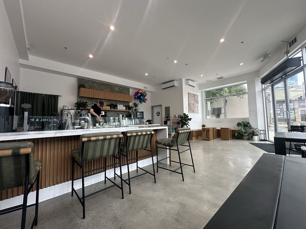 Interior of the Lynx Coffee shop with a curved wooden bar and warm lighting